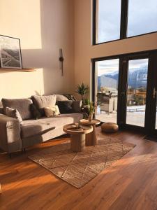a living room with a couch and a table at Altitude Escape Retreat in Fundata