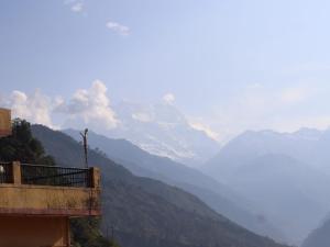 a view of a mountain range from a building at Chaukhamba view stay in Gupta Kāshi