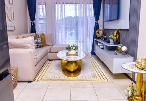 a living room with a couch and a table at Kunashe Apartments in Harare