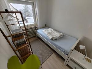 a small room with a bunk bed and a ladder at Ferienwohnung Asenberg in Bad Salzuflen