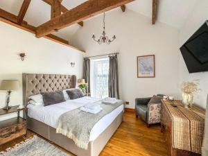 a bedroom with a large bed and a television at 3 Bed in Matlock oc-86482 in Cuckney