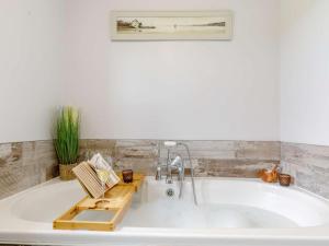 a bath tub with a faucet in a bathroom at 3 Bed in Matlock oc-86482 in Cuckney +30 photos