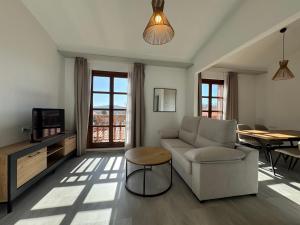 a living room with a couch and a table at Hotel Apartamento 3 Lobitos in Villardeciervos