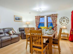 a living room with a table and a couch at 3 Bed in Bathgate oc-90491 in Fauldhouse