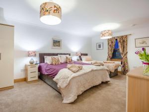 a bedroom with two beds and a dresser at 3 Bed in Bathgate oc-90491 in Fauldhouse