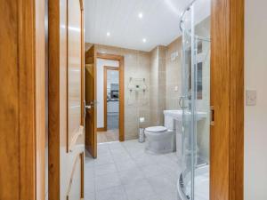 a bathroom with a toilet and a glass shower at 3 Bed in Bathgate oc-90491 in Fauldhouse +20 photos