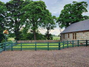 a green fence in front of a building at 3 Bed in Bathgate oc-90491 in Fauldhouse