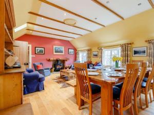 a living room with a wooden table and chairs at 6 Bed in Dunkeld oc-ca145 in Riechip