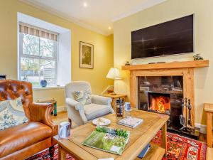 a living room with a table and a fireplace at 3 Bed in Inverness oc-ca134 in Farr