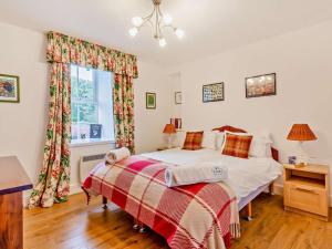 a bedroom with a bed and a window at 3 Bed in Inverness oc-ca134 in Farr