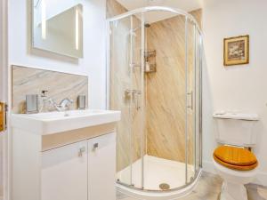 a bathroom with a shower with a toilet and a sink at 3 Bed in Inverness oc-ca134 in Farr +23 photos