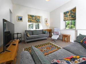 a living room with two couches and a tv at 2 Bed in Lockerbie oc-94304 in Brydekirk