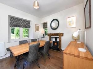a dining room with a table and chairs and a fireplace at 2 Bed in Lockerbie oc-94304 in Brydekirk +10 photos