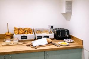 a counter with bread and other food on it at Vanbrugh House Hotel in Oxford