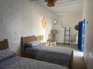 a bedroom with two beds and a ladder in it at Darnamed in Nador