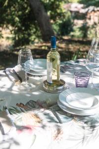 a table with plates and a bottle of wine at CollinaBlu in Torre San Severo