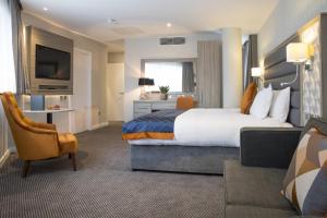 a hotel room with a large bed and a tv at Metro Hotel Dublin Airport in Santry