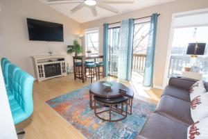 a living room with a couch and a table at The Little Penthouse in Lake Ozark