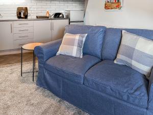 a blue couch with two pillows on it in a kitchen at Lily - Uk49362 in Bridlington