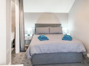 a bedroom with a bed with two blue towels on it at Lily - Uk49362 in Bridlington