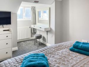 a bedroom with a bed and a desk and a television at Lily - Uk49362 in Bridlington +4 photos