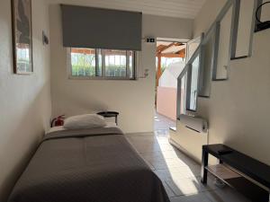 a small bedroom with a bed and a window at Eretria Lofts in Eretria