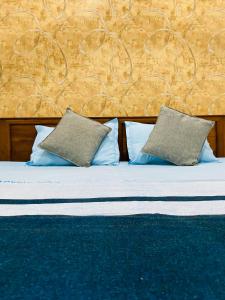 a bed with two pillows on top of it at VD Rest Gampola in Gampola