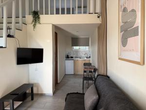 a living room with a couch and a kitchen at Eretria Lofts in Eretria