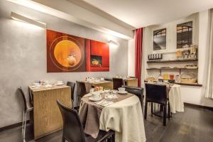 a dining room with two tables and chairs in a restaurant at Hotel Rinascimento in Rome