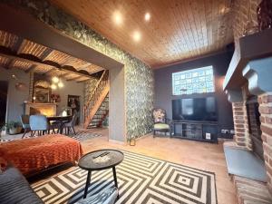 a bedroom with a bed and a television in a room at Suite Home in Crespin