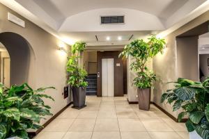 a corridor with potted plants in a hallway at Hotel Rinascimento in Rome