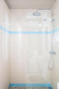 a bathroom with a shower with a glass door at Majordoms Retrocentric in Banyoles +17 photos