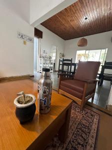 a living room with a vase on a table at BichoNegro Hostel in Concordia