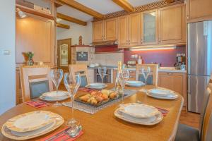 a kitchen with a table with plates and wine glasses at Vineyard Cottage Stepan in Črnomelj +30 photos