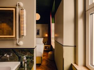 a bathroom with a sink and a bed in a room at The Companion Vienna in Vienna +82 photos