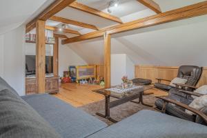 a living room with a couch and a table at Vineyard Cottage Stepan in Črnomelj