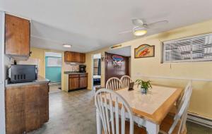 a kitchen and dining room with a table and chairs at The Driftwood in Old Orchard Beach
