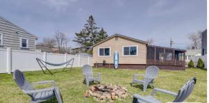 a yard with chairs and a fire pit and a house at The Driftwood in Old Orchard Beach +6 photos