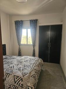 a bedroom with a bed and a window at Mimi in Dakar