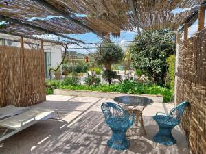 a patio with a table and chairs and a bench at Casa Papaver Casita in Coín