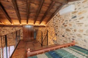 a room with a staircase in a stone wall at Mystras Panorama House in Mystras