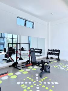 a gym with two chairs and treadmills in a room at Acquila Crest by JKIA in Nairobi