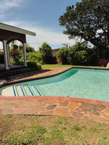 a swimming pool in the yard of a house at Preston House in Park Rynie