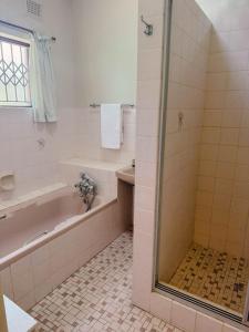 a bathroom with a bath tub and a shower at Preston House in Park Rynie