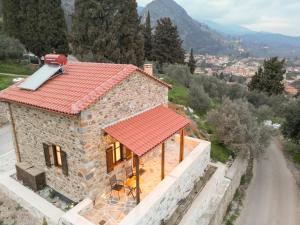 a small stone house with a red roof at Mystras Panorama House in Mystras