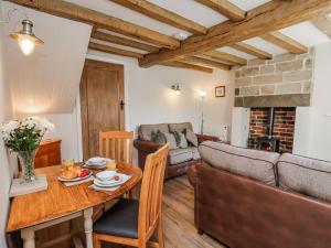 a living room with a table and a couch at Holly Cottage in Whitby