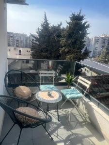 a balcony with a table and chairs on a balcony at SunnyBar in Bar