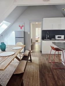 a kitchen with a table and a dining room at Appartement au port Le Mont-Saint-Michel in Dinan +26 photos