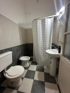 a bathroom with two toilets and a sink at BichoNegro Hostel in Concordia +16 photos