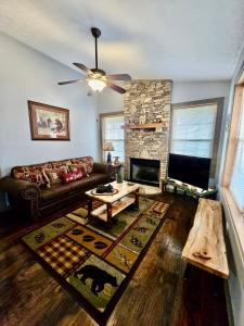 a living room with a couch and a fireplace at Hidden Love in Gatlinburg
